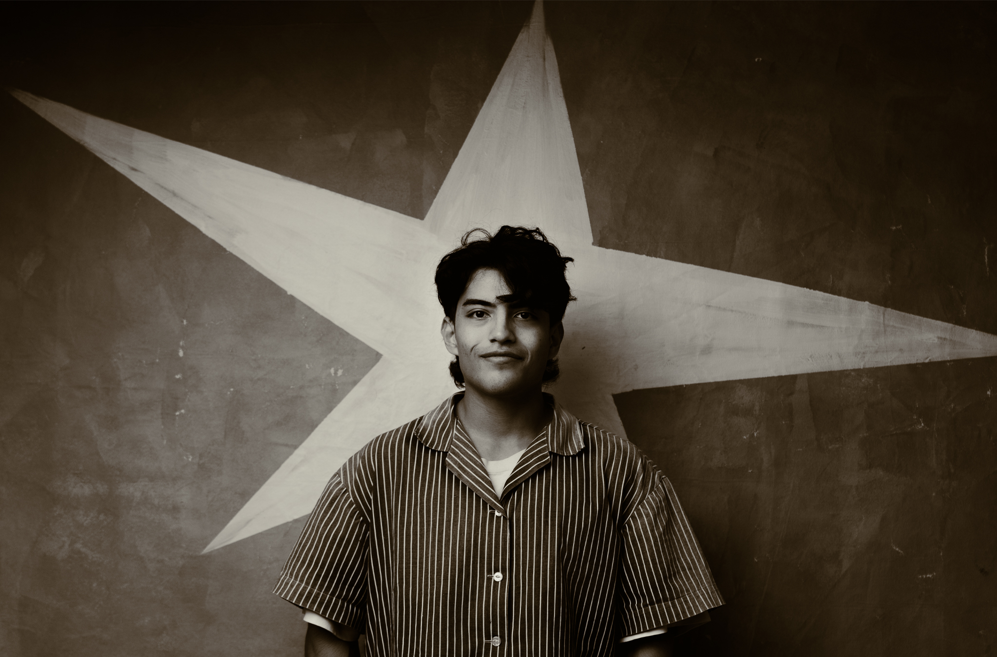Peter Sanjur in front of a painted star, self-portrait, 2026