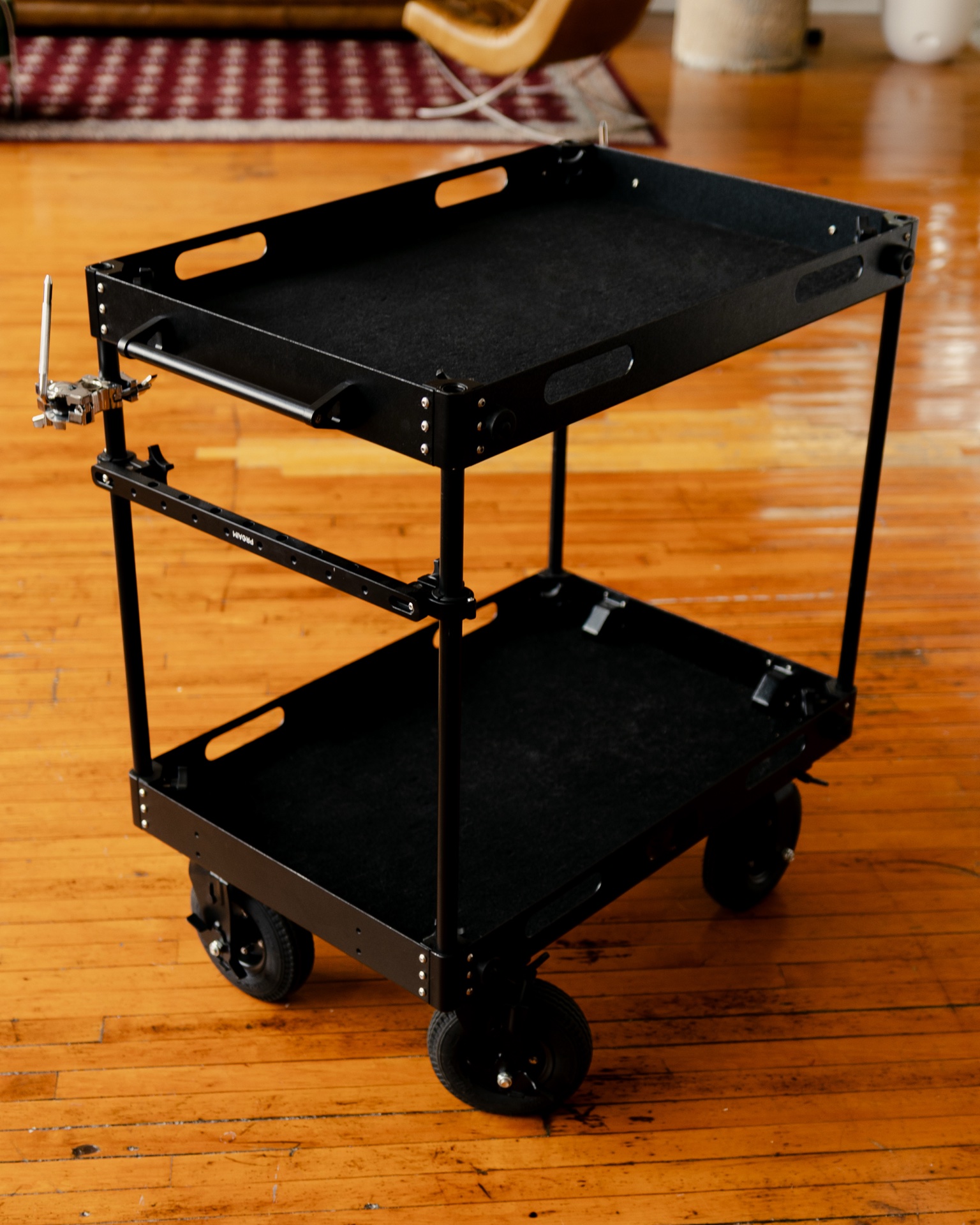 The studio's black production cart on the wood floor